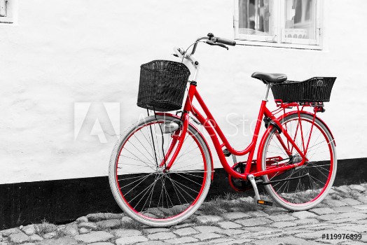 Bild på Retro vintage red bicycle on cobblestone street in the old town
